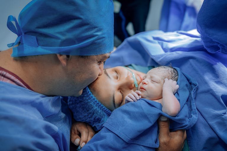 A touching moment of a newborn with parents in a hospital after delivery.