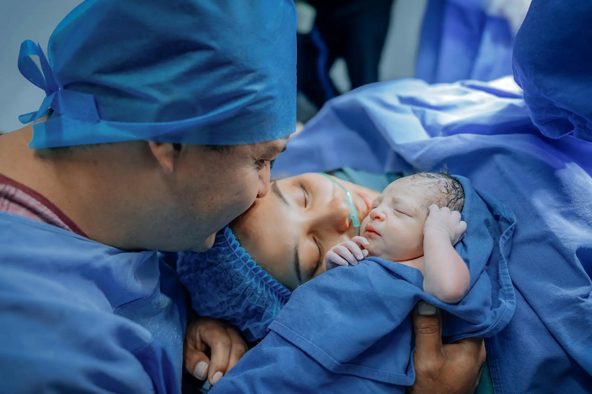 A touching moment of a newborn with parents in a hospital after delivery.